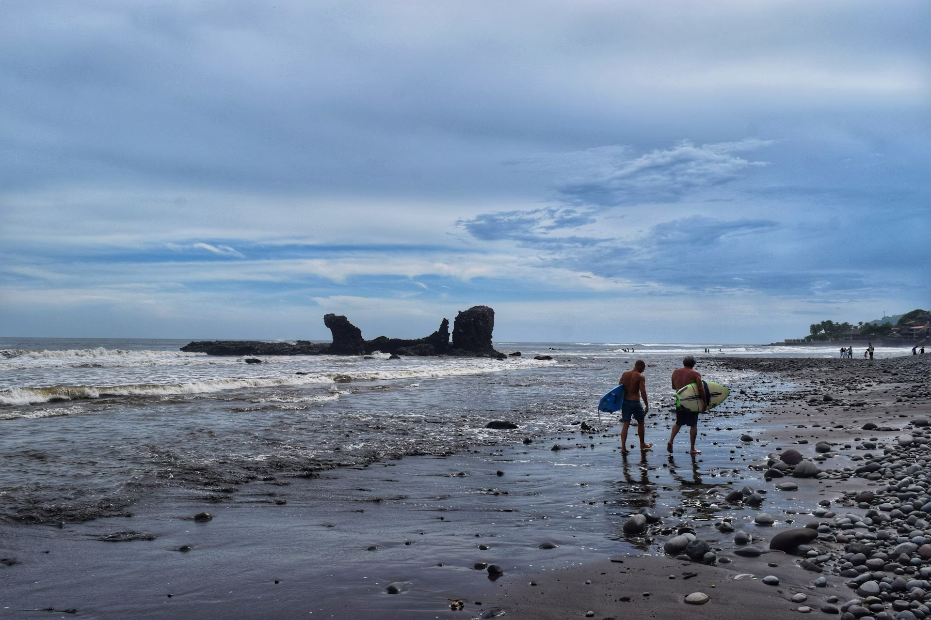 Surfers at sunset, El Tunco beach, El Salvador